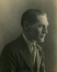 black and white profile picture of a man, my grandfather, wearing a coat and tie