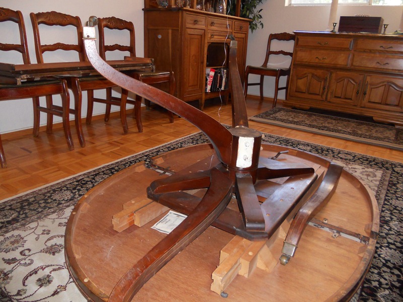 dining room table upside-down, displaying two broken table legs