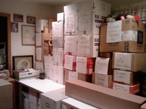 desktop covered in stacks of labeled boxes