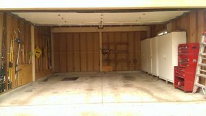 completely organized two car garage with white storage cabinets and red tool chest