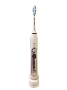 sonicare toothbrush standing upright on charging device